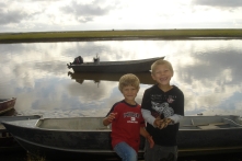 The boys loved to explore and walk around town. Here they are climbing on boats near the river.